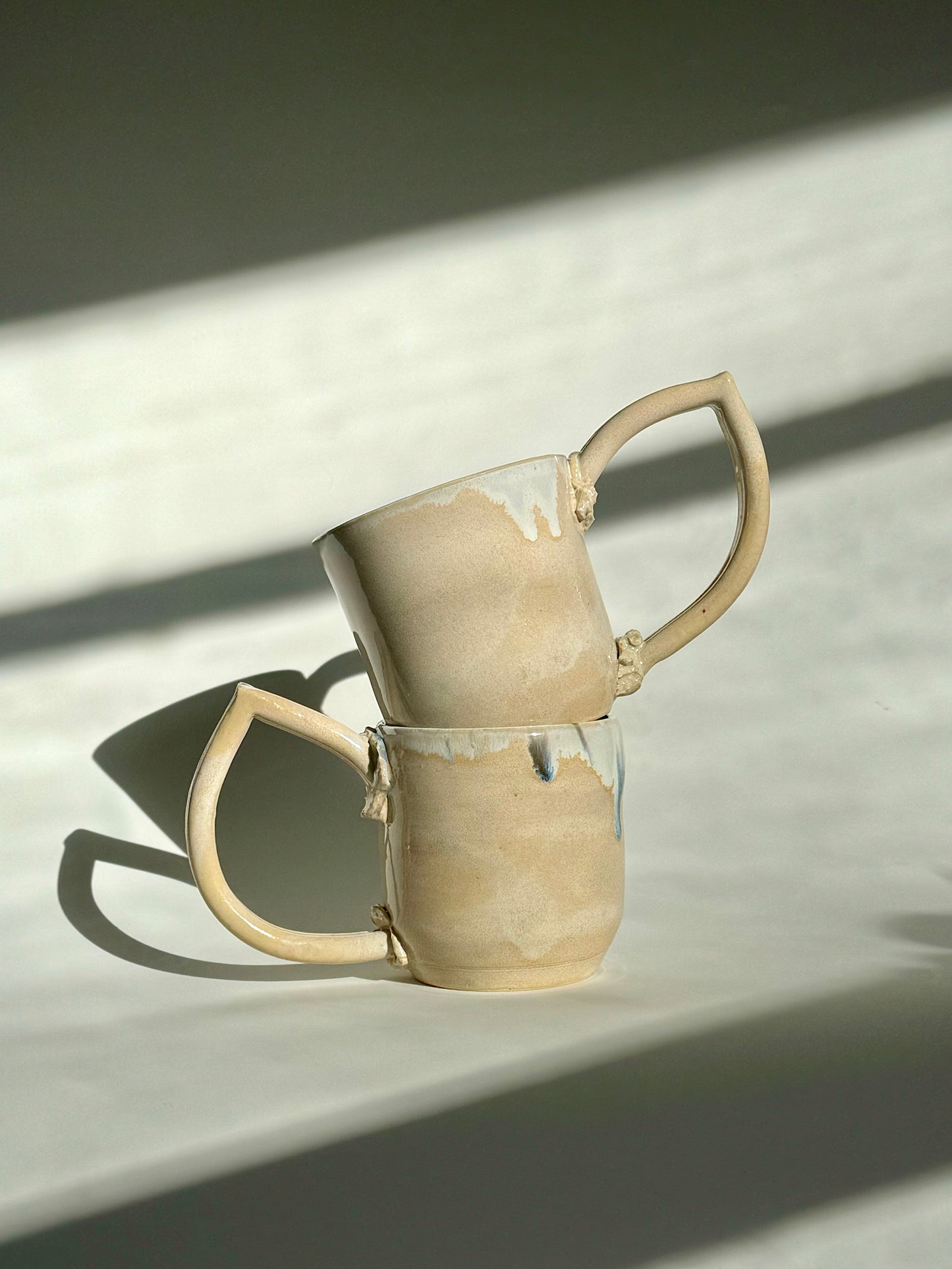 Teardrop Handle Mugs (pair) - only from Rita Strayer Ceramics of Savannah. Stacked view of the pair of mugs, with handles facing opposite directions.
