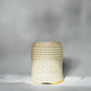 Turned over view of the textured ceramic tumbler with yellow glaze on a blackish-grey background. Sustainably made by Savannah ceramicist Rita Strayer.