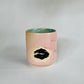 Straight over view of the Small Kissy Cup Tumbler by Rita Strayer Ceramics of Savannah. This design features a cascading flux rim, various sea foam interior and celadon bloom shads. Stoneware, microwavable, black lip design with pink dominant colors.