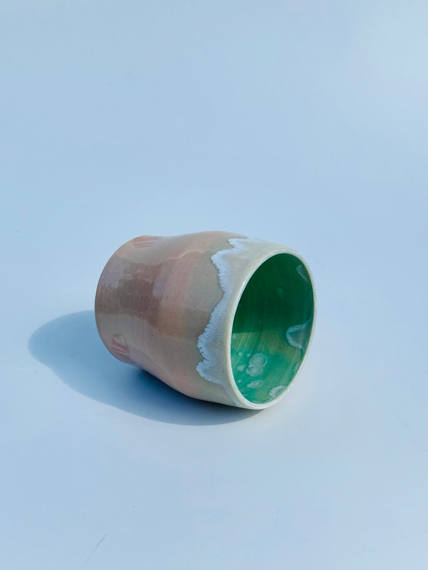 On its side view of the rare Nerikome Heart Tumbler from Rita Strayer Ceramics of Savannah. Subtle heart motif. Suitable cup for milk, nightstand water, wine, whiskey & juice. Various colors in this design.