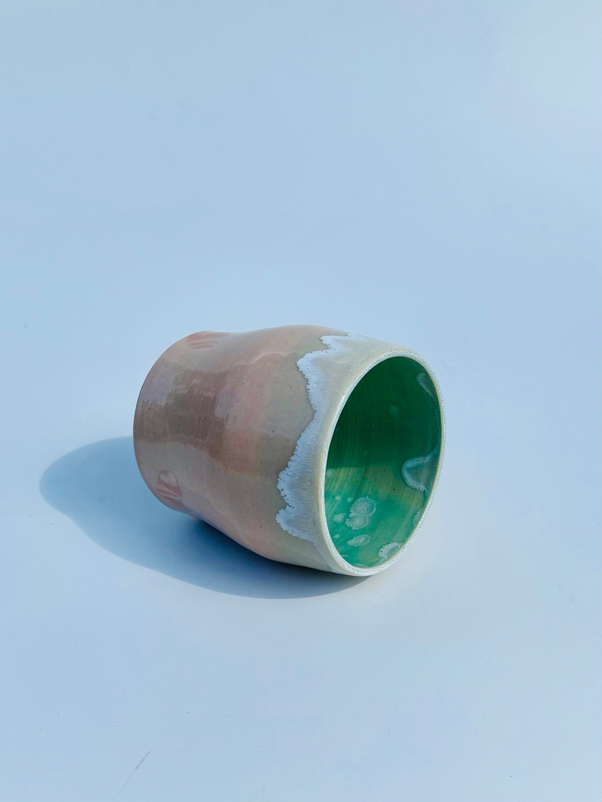 On its side view of the rare Nerikome Heart Tumbler from Rita Strayer Ceramics of Savannah. Subtle heart motif. Suitable cup for milk, nightstand water, wine, whiskey & juice. Various colors in this design.