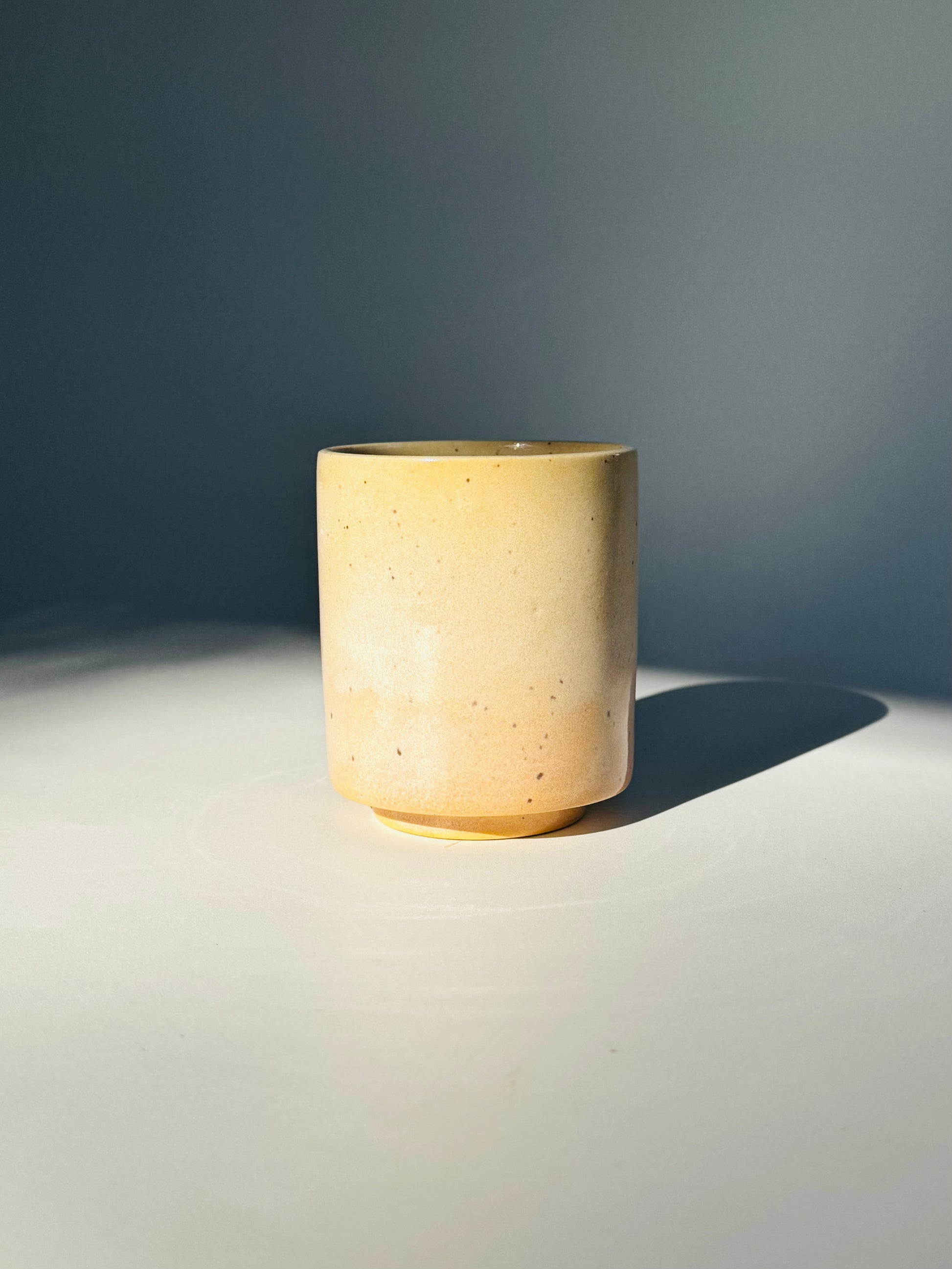 Straight on view of the unique Subtle Speckles Straight Cup by Rita Strayer Ceramics Savannah. A tasteful little 6oz tumbler. Very faint speckle pattern appears throughout the clay mix.