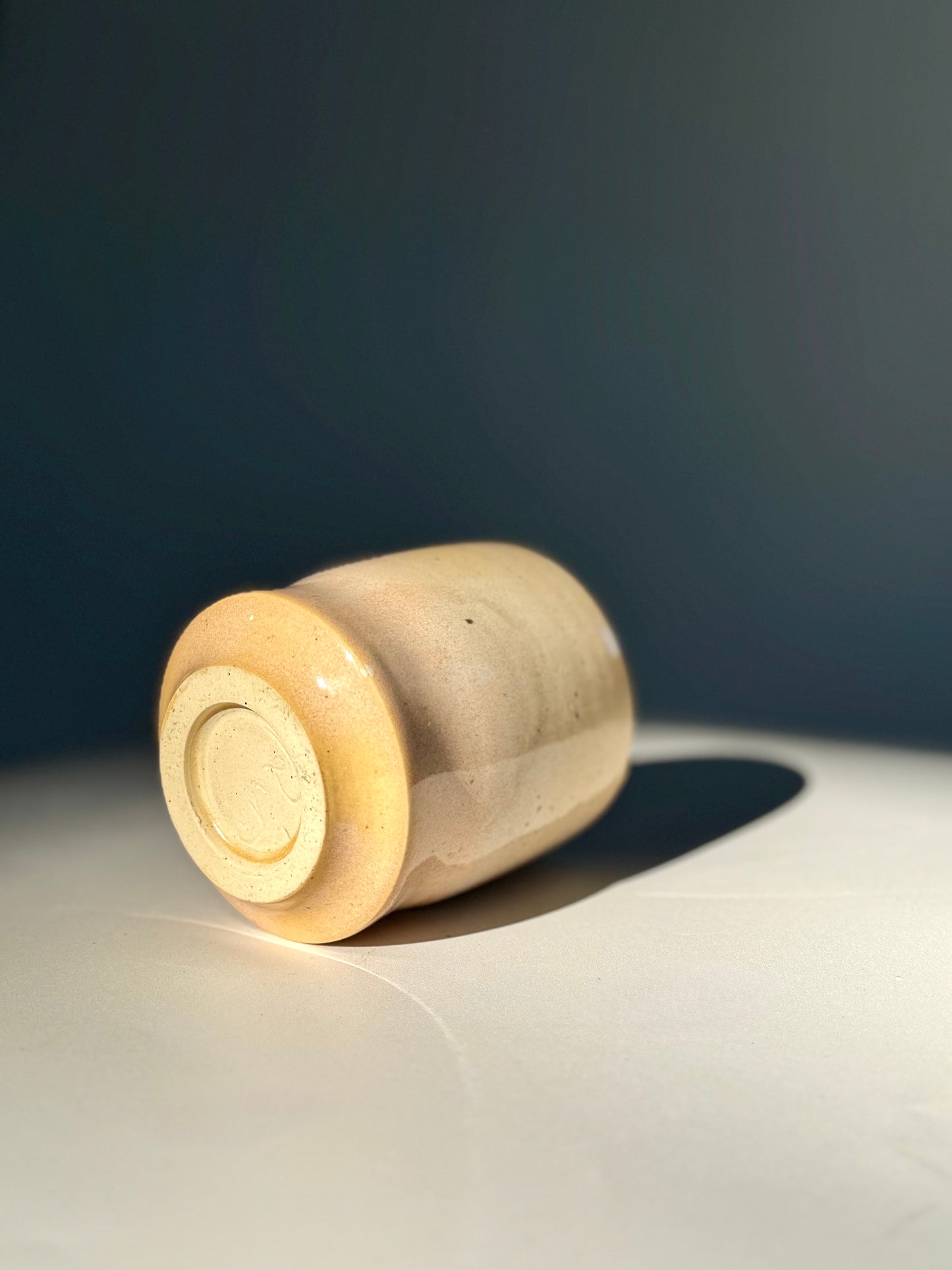 Tumbled side view of the Unique Subtle Speckles Grooved Cup from Rita Strayer Ceramics Savannah. A tasteful little 6oz tumbler with grooves for small fingers. Faint speckle pattern.