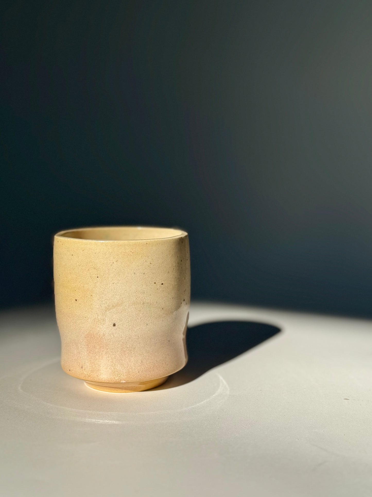 Upright view of the Unique Subtle Speckles Grooved Cup from Rita Strayer Ceramics Savannah. A tasteful little 6oz tumbler with grooves for small fingers. Faint speckle pattern.