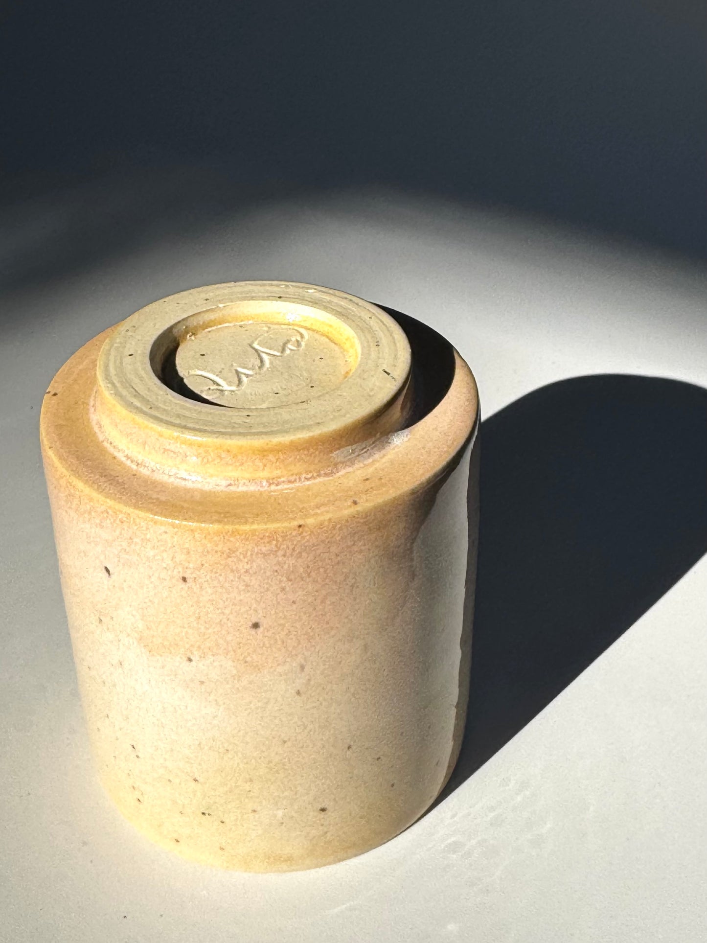 Upside down from close up view of the unique Subtle Speckles Straight Cup. Note the logo for Rita Strayer Ceramics Savannah. A tasteful little 6oz tumbler. Very faint speckle pattern appears throughout the clay mix.