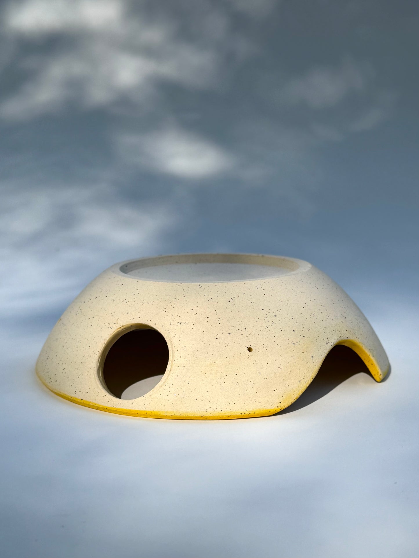 Upside down view of the classic yellow two thumb hole herb stripper with Garlic Grater by Rita Strayer Ceramics of Savannah. Easily strip leaves of your favorite herb. Stoneware clay.